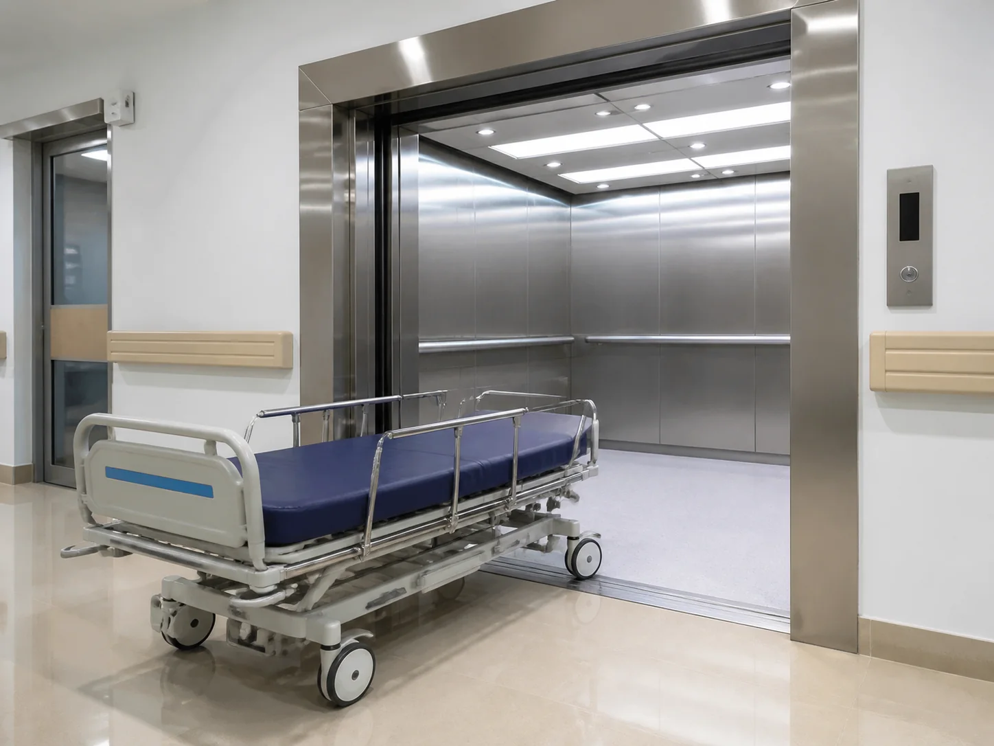 Hospital bed elevator with stretcher-width car