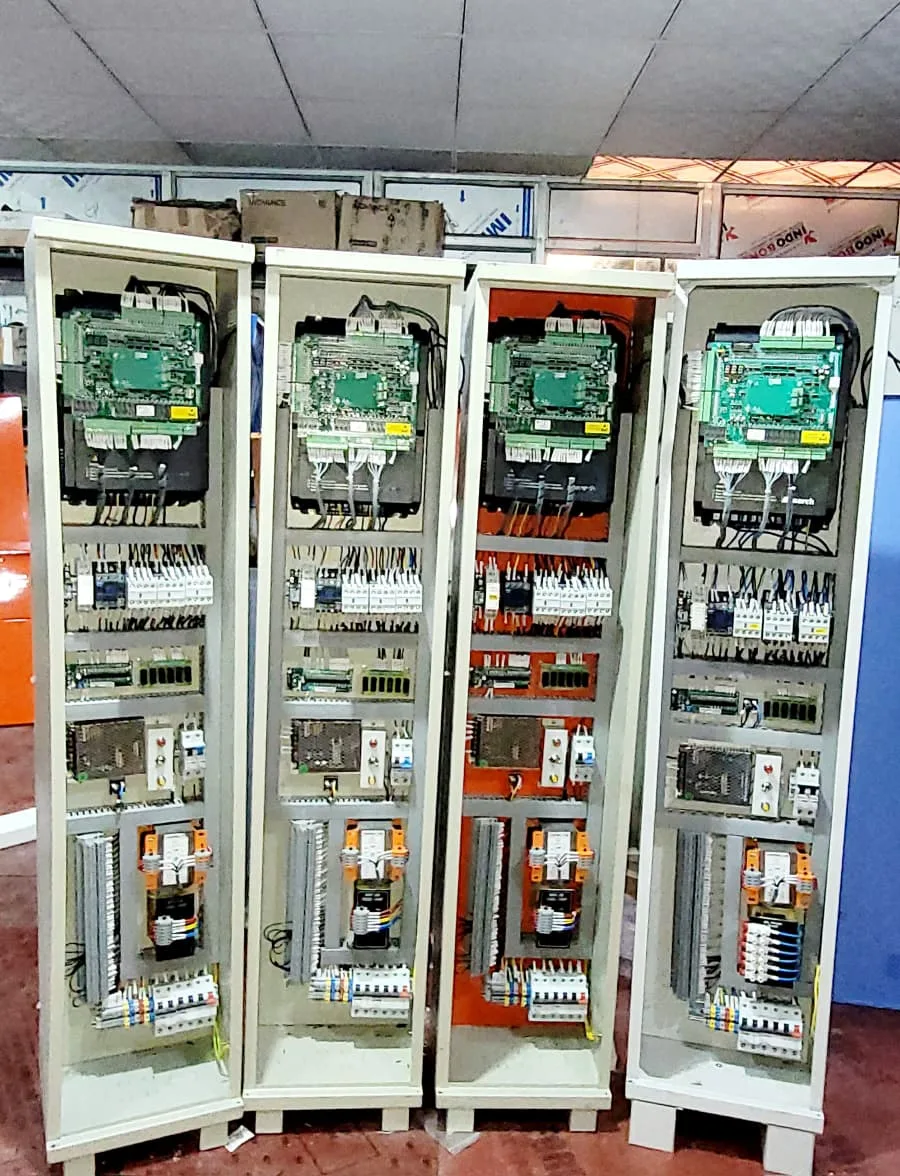 Row of assembled elevator control panels ready for installation