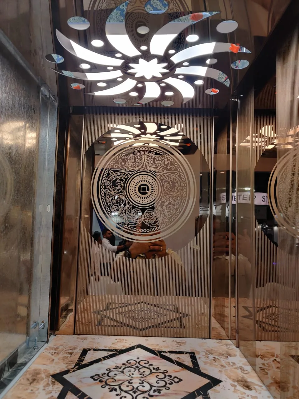 Premium elevator cabin interior with decorative mirrored ceiling panel