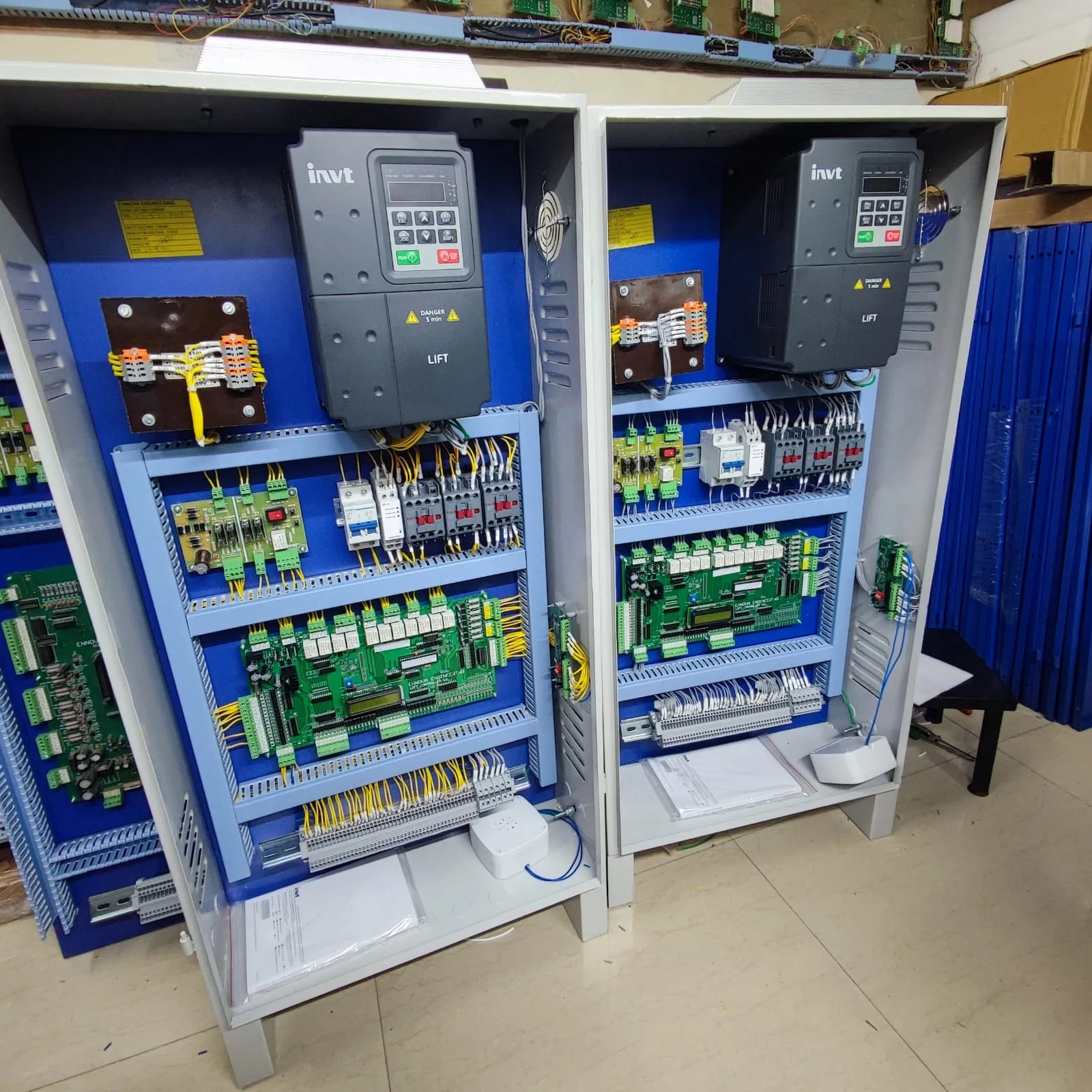 Two elevator control panels with INVT drives assembled side by side