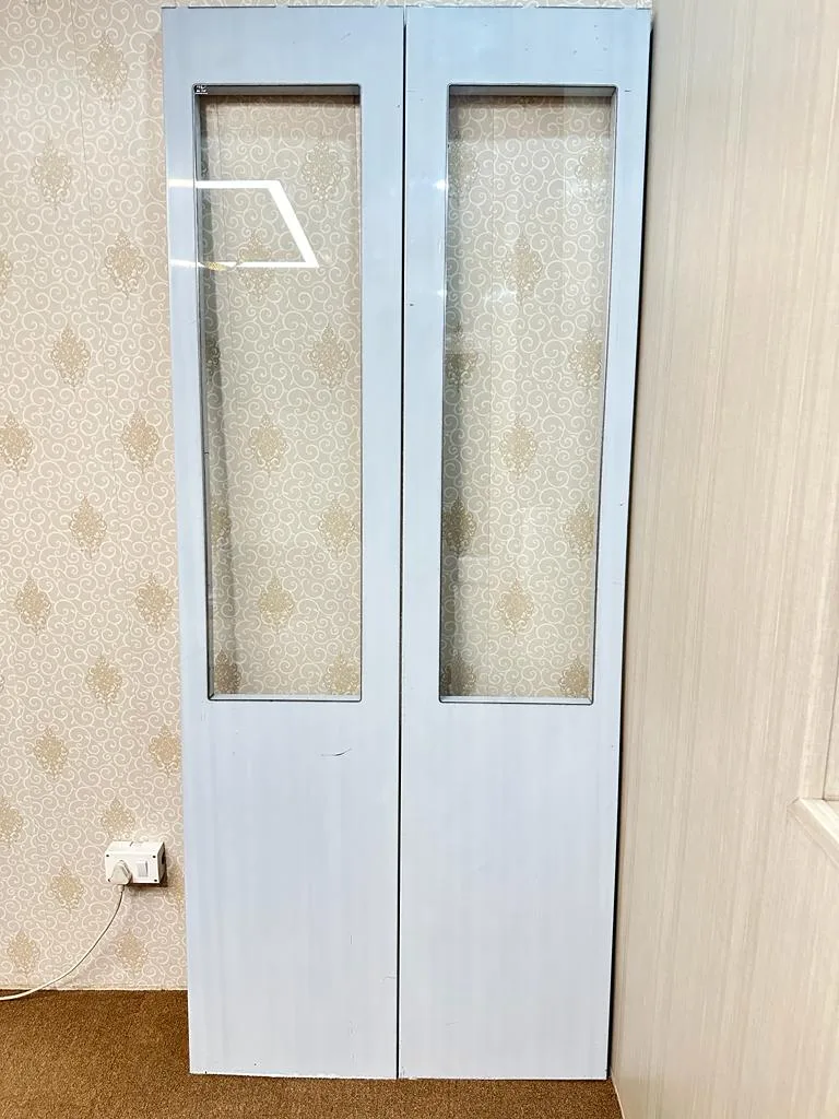 Glass-panel folding elevator door installed in a home